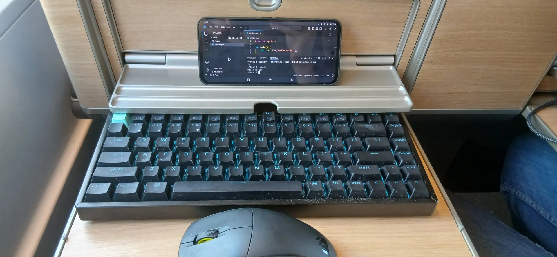 photo of a linux phone with vscodium with a mouse and keyboard on a train