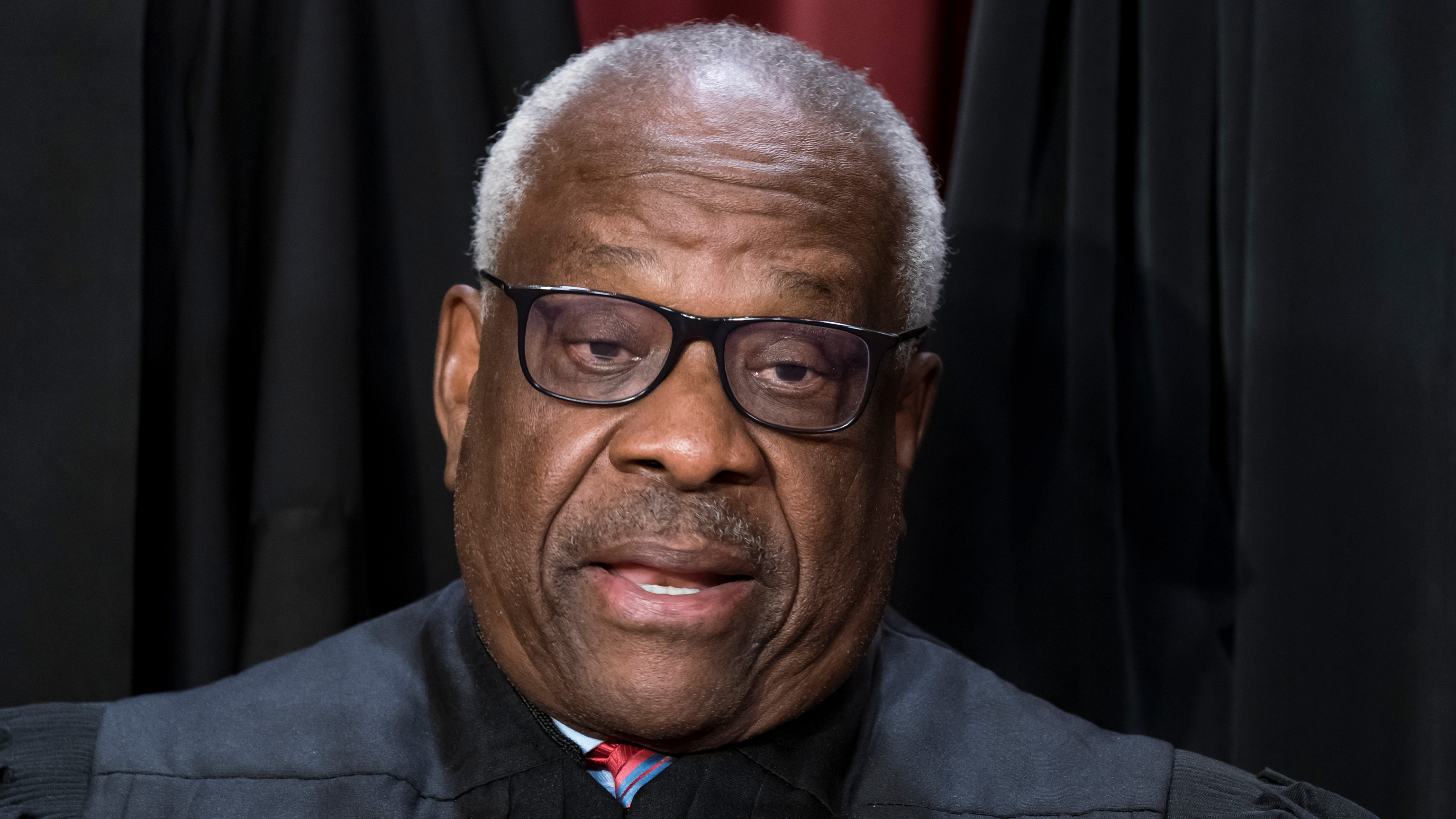 FILE - Associate Justice Clarence Thomas poses for a photo at the Supreme Court building in Washington, Oct. 7, 2022.