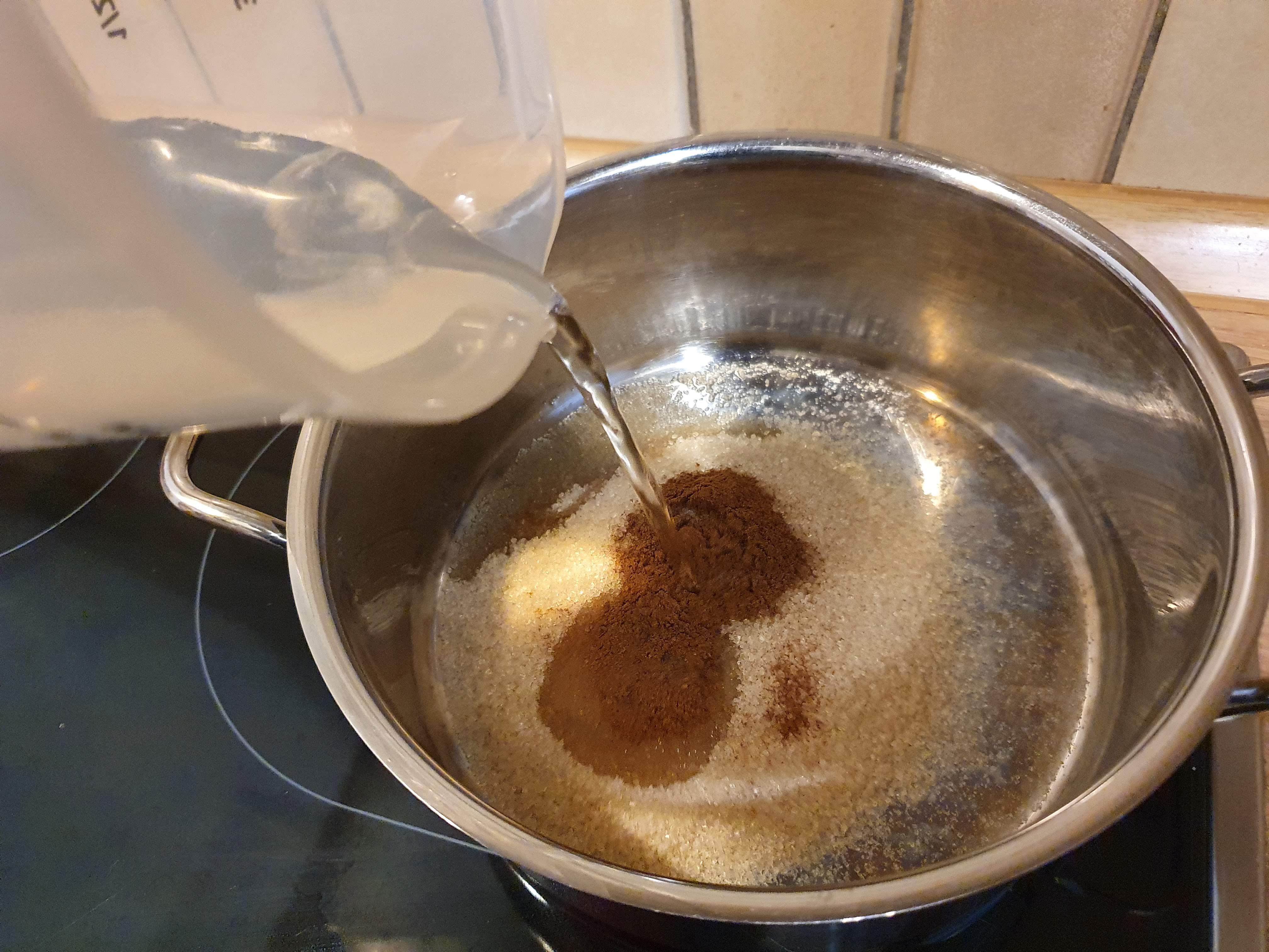 Wasser, Zucker, Vanielle und Zimt in einem Topf