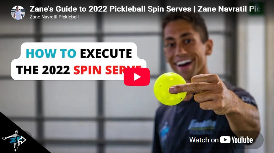 A person holds a pickleball in such a way that he's showing you only his middle finger.