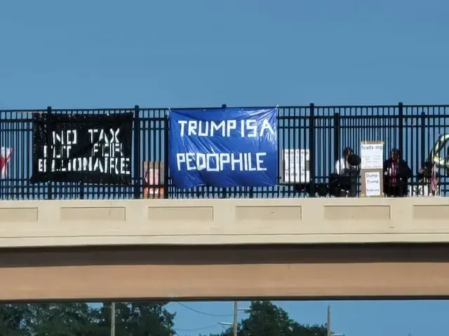 Trump is a pedophile sign hung over a highway overpass