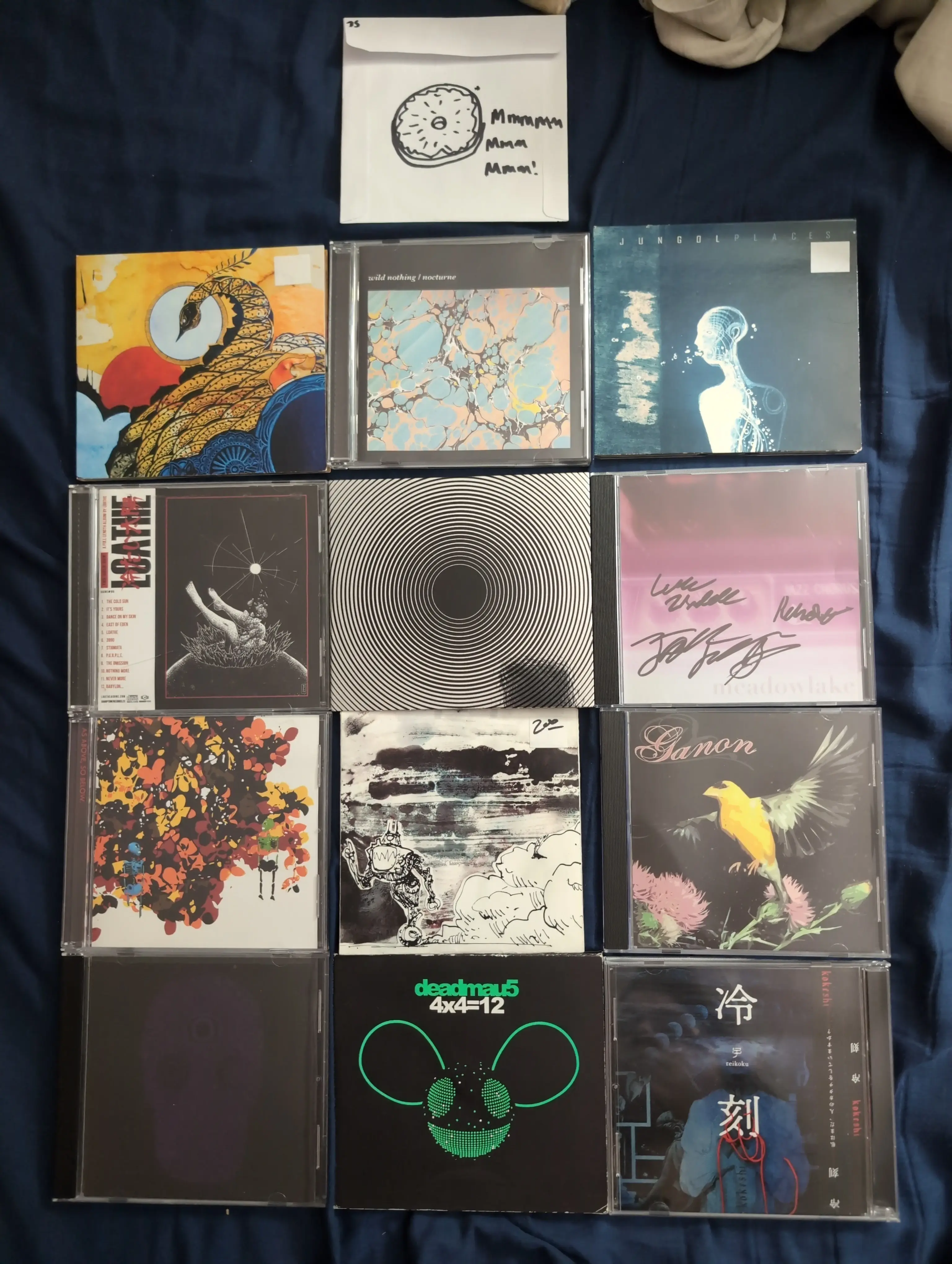 A photo of a bunch of CDs, most without titles on the cover.