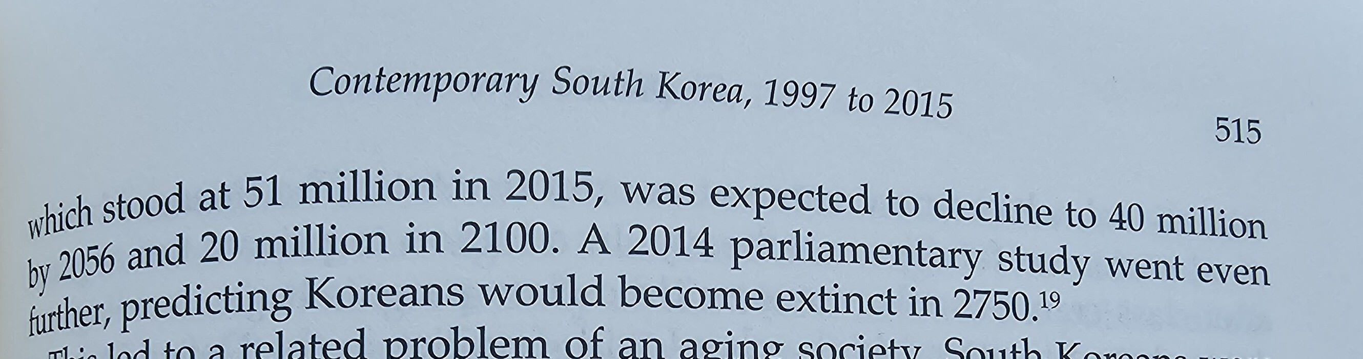 The top of page 515 of a book in the chapter "Contemporary South Korea, 1997 to 2015". It reads (continued from the previous page): "[...] which stood at 51 million in 2015, was expected to decline to 40 million by 2056 and 20 million in 2100. A 2014 parliamentary studyd went even further, predicting Koreans would become extinct in 2750."