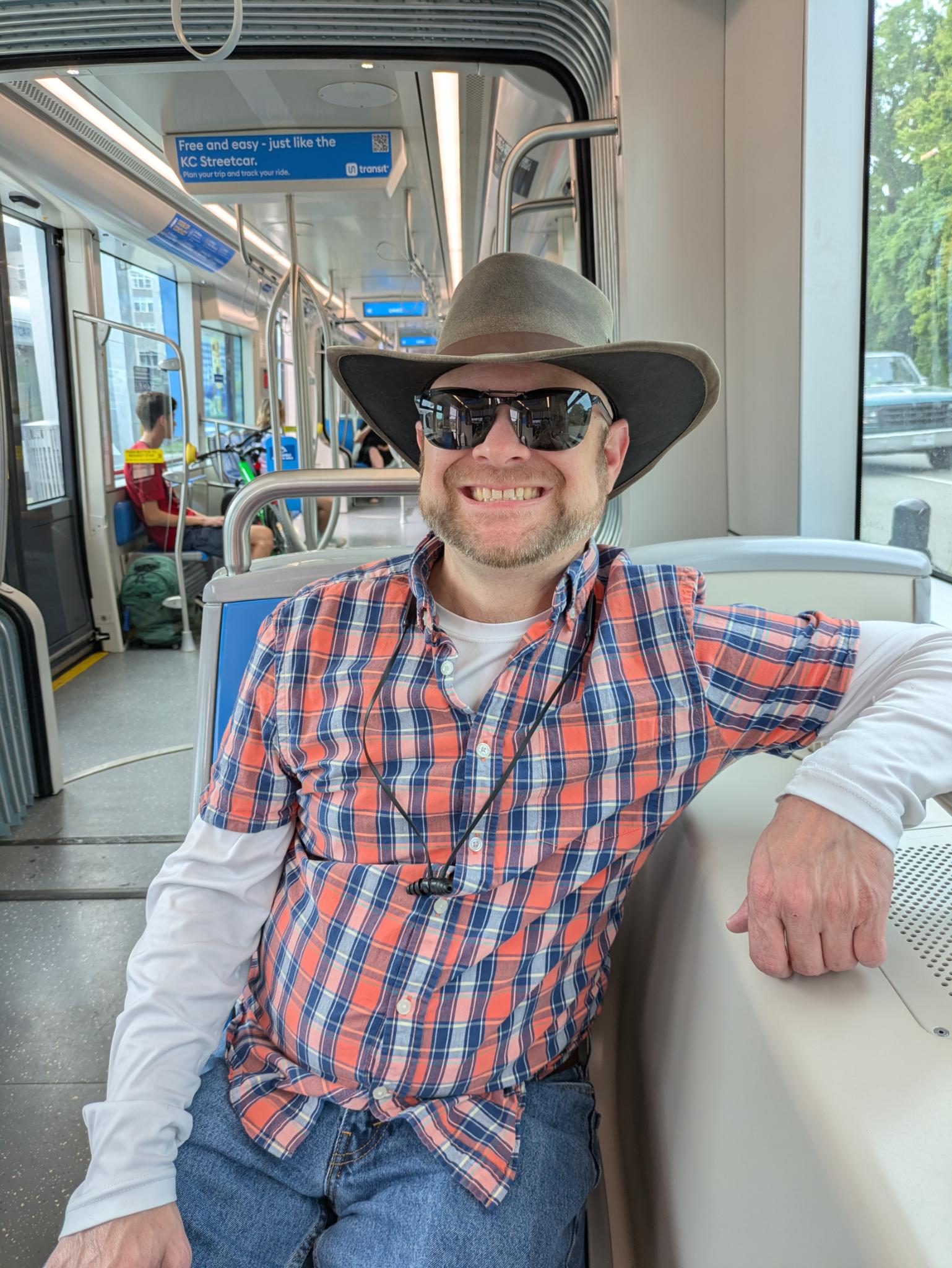 Handsome man riding a tram.