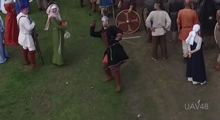 Viking reenactor throws spear at drone